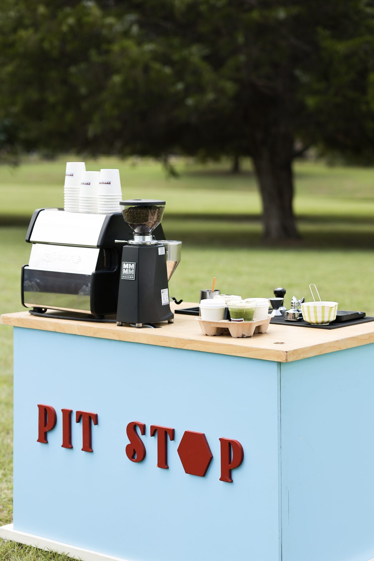 Pit Stop Coffee's espresso machine and grinder set up on the cart